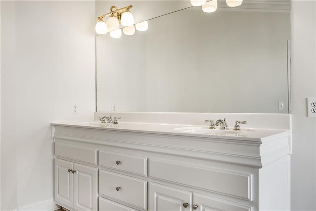 2013 Cockrell Run Northwest Kennesaw, GA 30152 - Photo 31 of 69 a bathroom with a sink vanity and a mirror