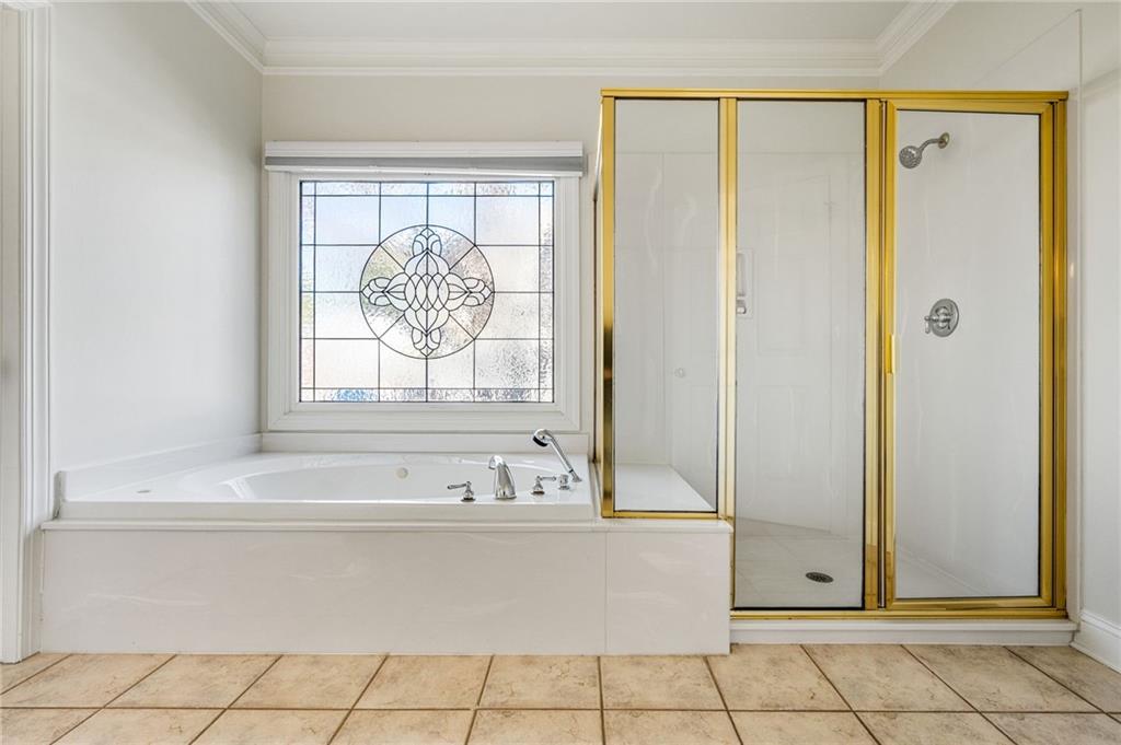 2013 Cockrell Run Northwest Kennesaw, GA 30152 - Photo 32 of 69 a bathroom with a bathtub and a shower