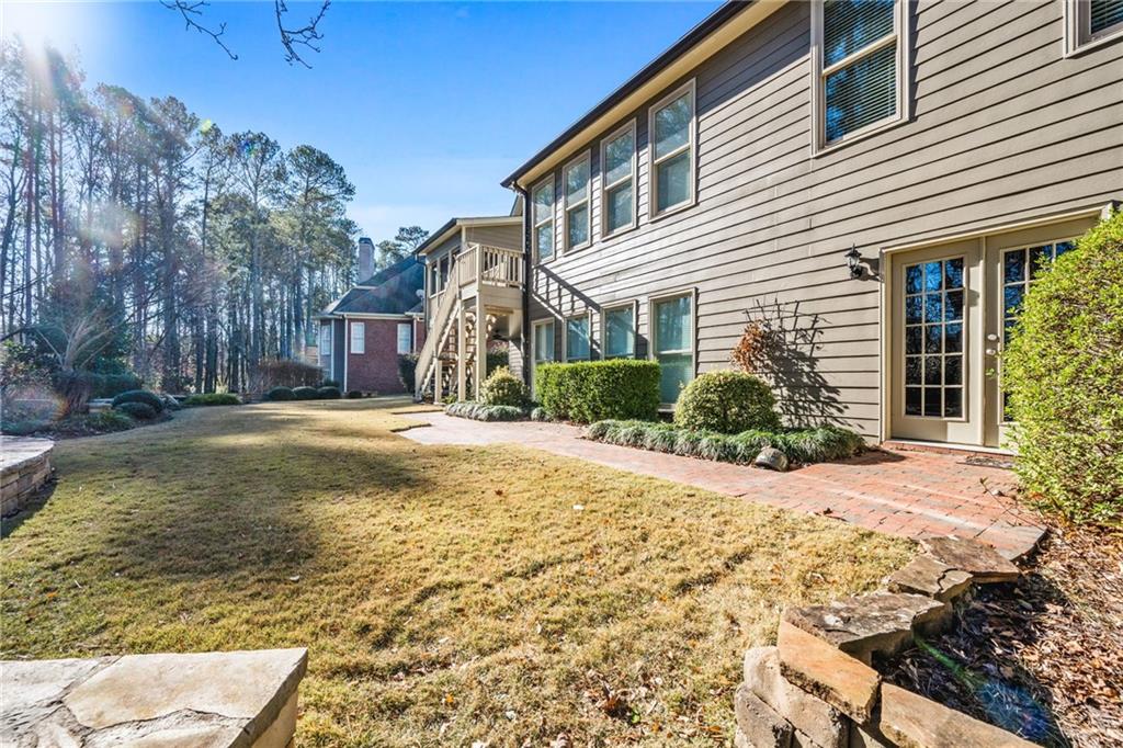 2013 Cockrell Run Northwest Kennesaw, GA 30152 - Photo 62 of 69 a house with a yard covered with trees in front of it