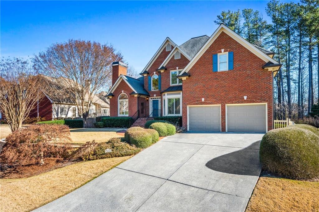 2013 Cockrell Run Northwest Kennesaw, GA 30152 - Photo 8 of 69 a front view of a house with a yard and garage