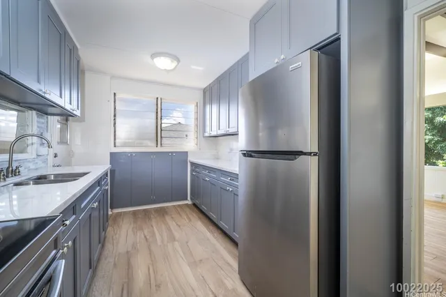 a kitchen with a refrigerator sink and cabinets