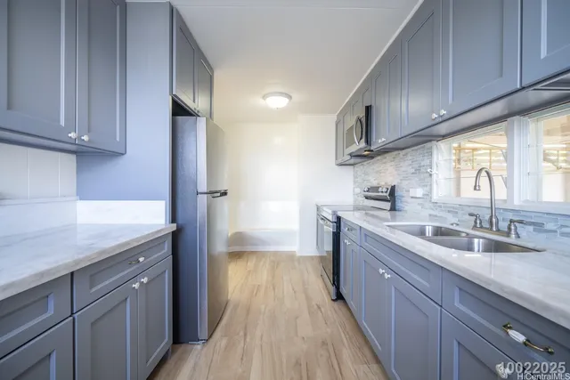 a kitchen with granite countertop wooden cabinets a sink and dishwasher