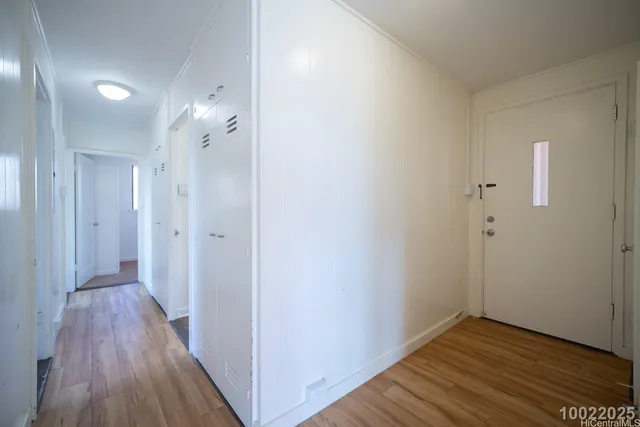 a view of hallway with wooden floor