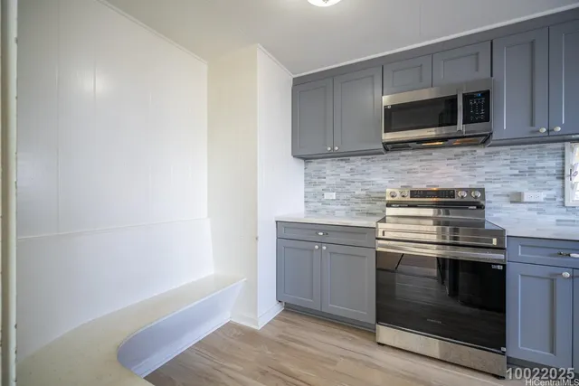 a kitchen with granite countertop a stove and a microwave
