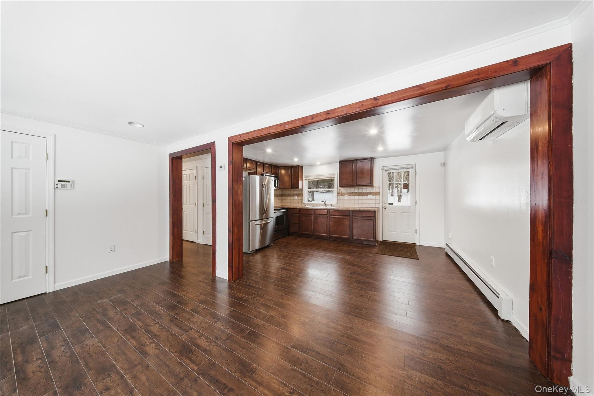 38 Rose Road Woodbourne, NY 12788 - Photo 4 of 35 a view of a hallway with wooden floor and a kitchen