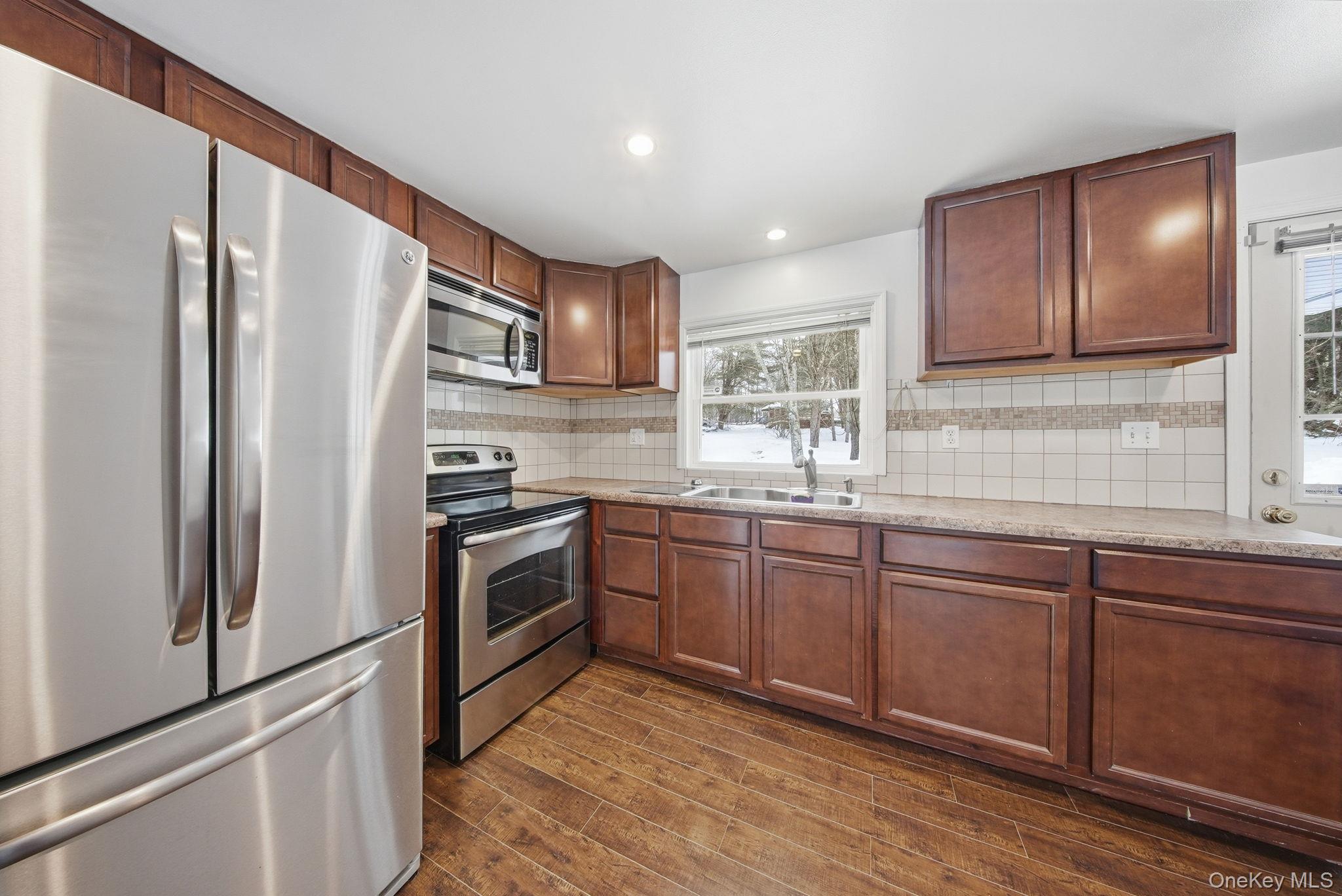 38 Rose Road Woodbourne, NY 12788 - Photo 5 of 35 a kitchen with granite countertop stainless steel appliances and wooden cabinets
