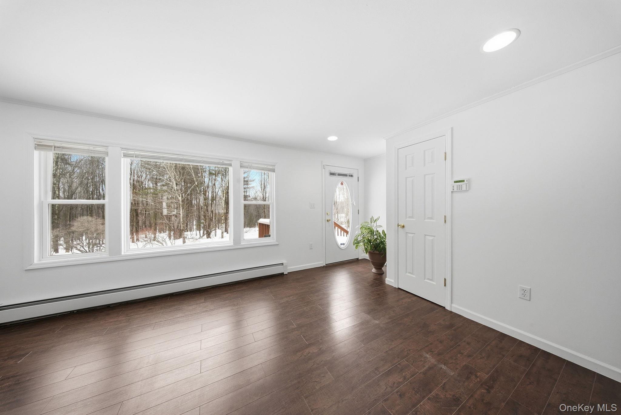 38 Rose Road Woodbourne, NY 12788 - Photo 6 of 35 an empty room with wooden floor and windows