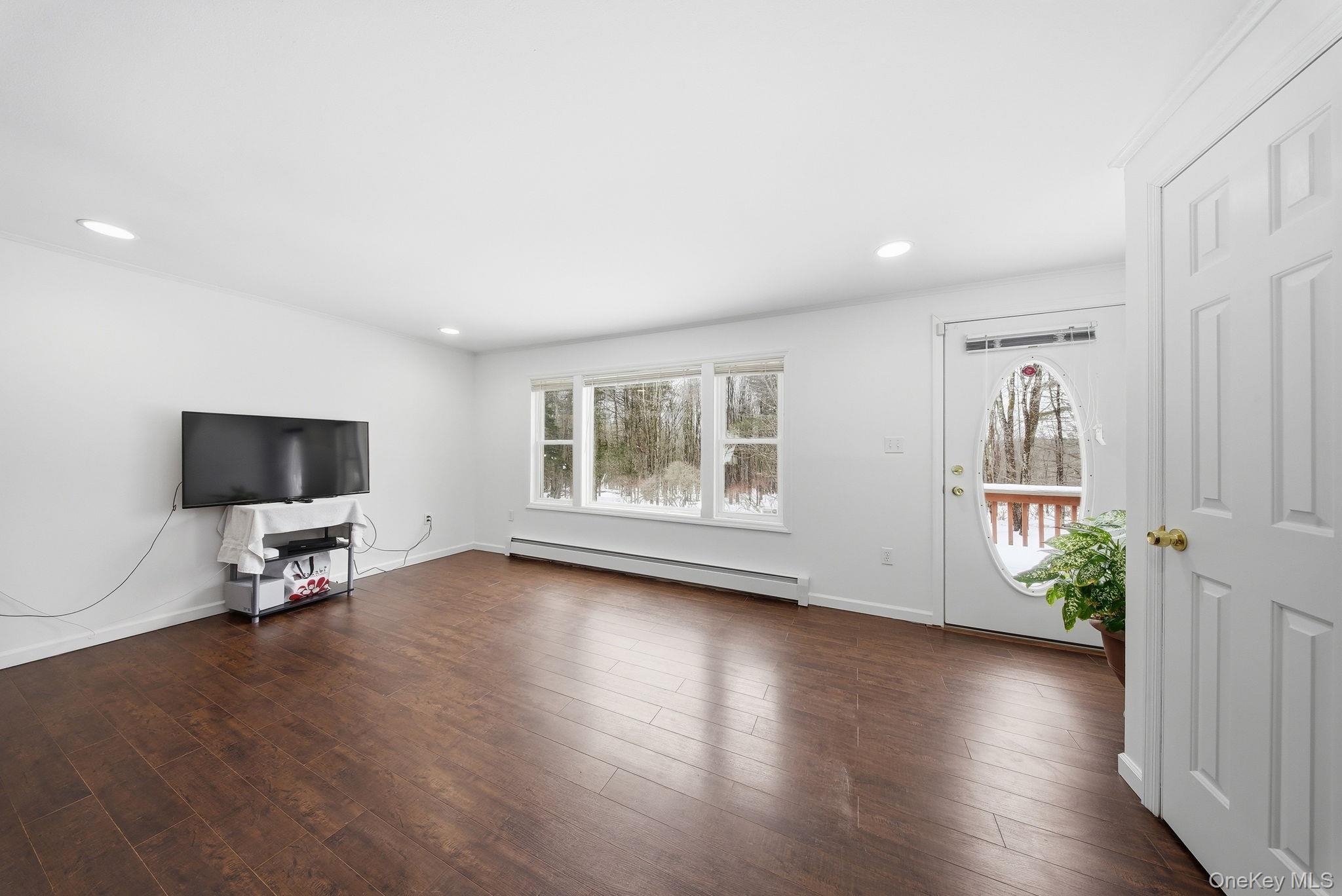 38 Rose Road Woodbourne, NY 12788 - Photo 7 of 35 a view of a livingroom with wooden floor and a flat screen tv