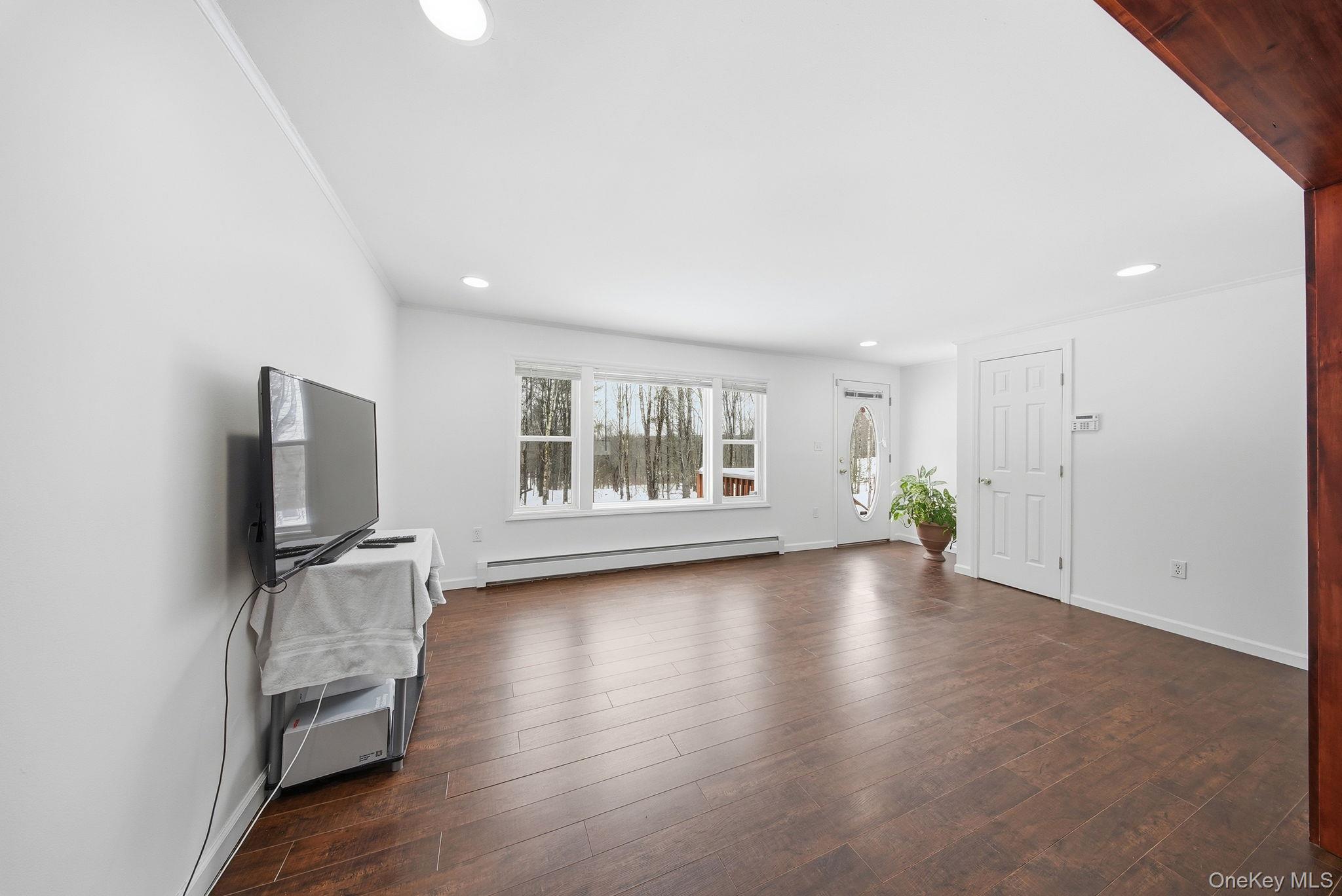 38 Rose Road Woodbourne, NY 12788 - Photo 9 of 35 an empty room with wooden floor and windows