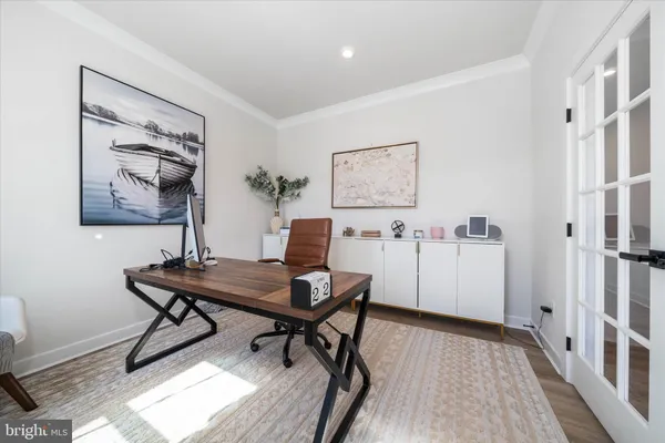 a view of a workspace with furniture and wooden floor