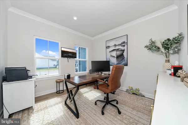 a workspace with furniture window and wooden floor