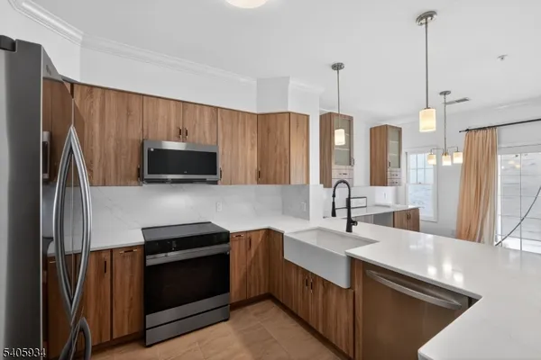 a kitchen with stainless steel appliances a sink stove and refrigerator