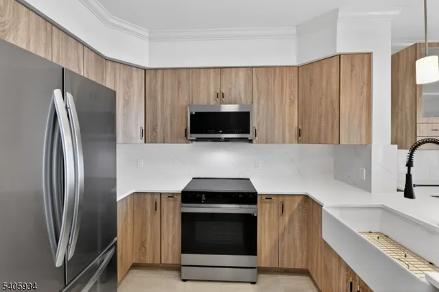 a kitchen with granite countertop a refrigerator and a sink