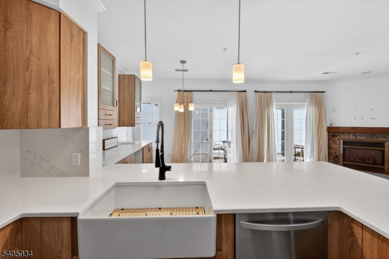 8-13 Maple Crescent, Unit 12 Vernon, NJ 07462 - Photo 4 of 18 a kitchen with kitchen island a counter top space a sink a counter space and a window