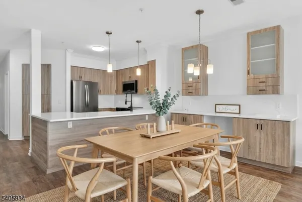 a kitchen with a dining table and chairs