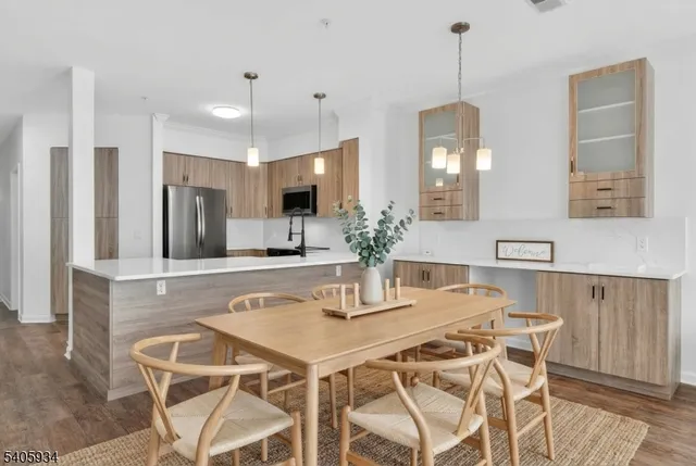 a kitchen with a dining table and chairs