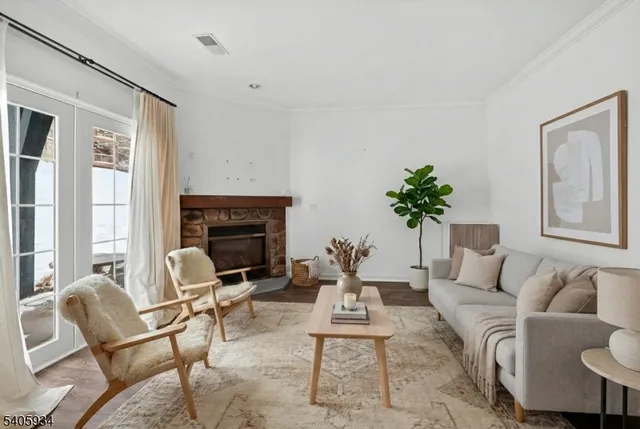 a living room with furniture a potted plant and a fireplace
