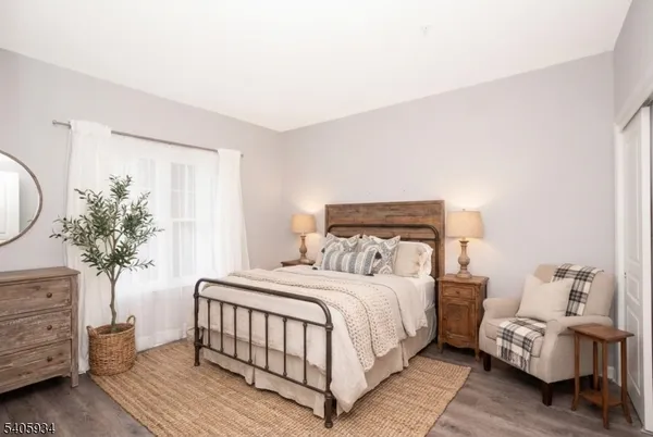 a bedroom with a bed and a mirror on dresser