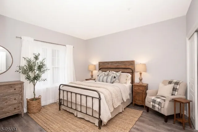 a bedroom with a bed and a mirror on dresser