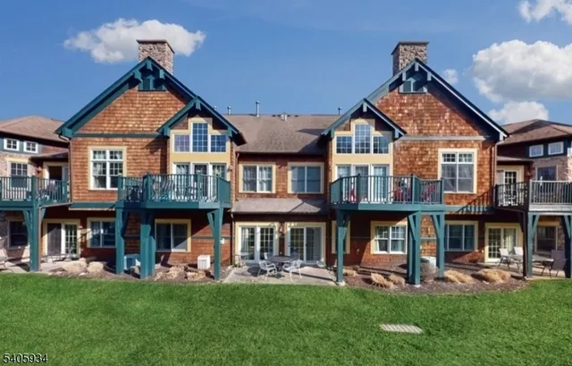 a front view of a house with a yard table and chairs