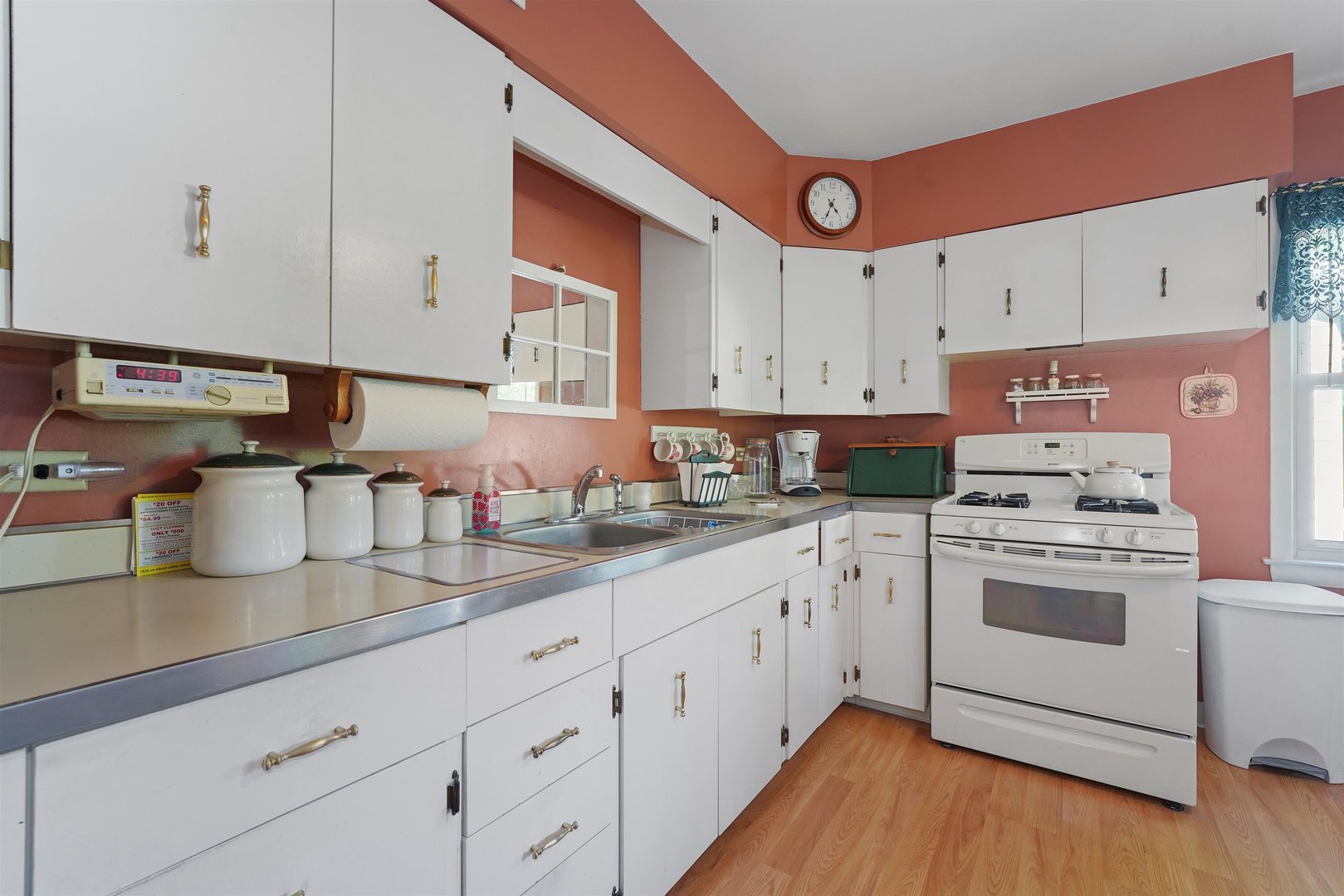 205 East Burlington Street Riverside, IL 60546 - Photo 9 of 19 a kitchen with cabinets appliances wooden floor and a window
