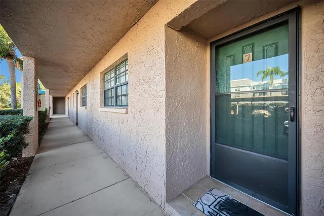 a living room with furniture a lamp and a flat screen tv