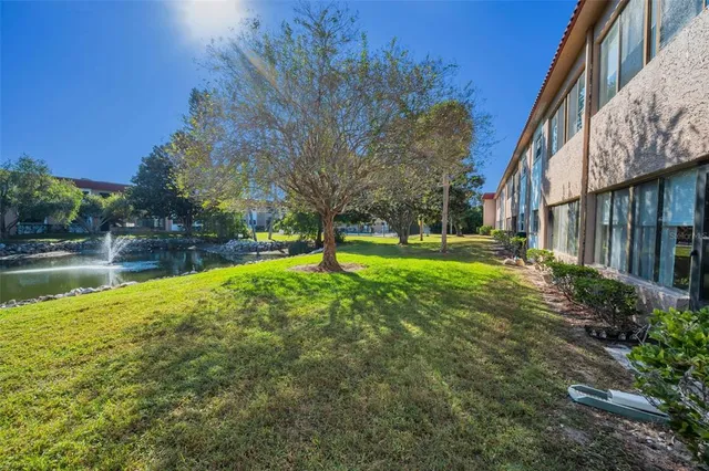 a view of a dining room with furniture and a floor to ceiling window
