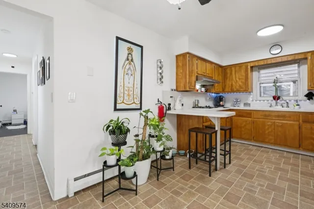 a kitchen with granite countertop white cabinets and white appliances