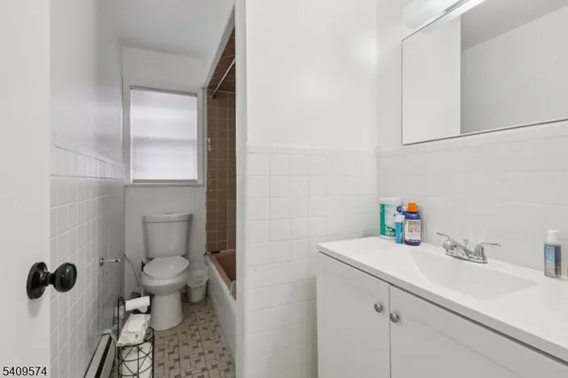 a view of a white house with a yard covered in snow