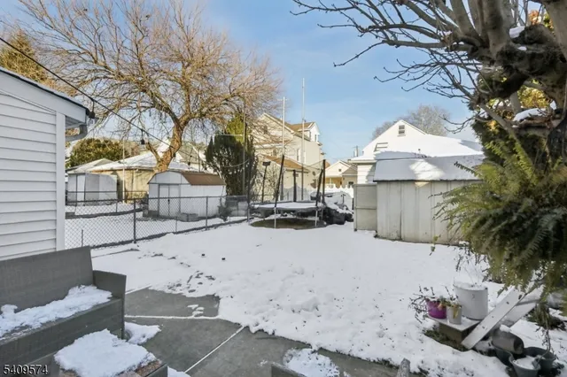a front view of a house with a yard covered in snow