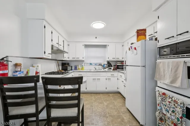 a kitchen with cabinets and wooden floor