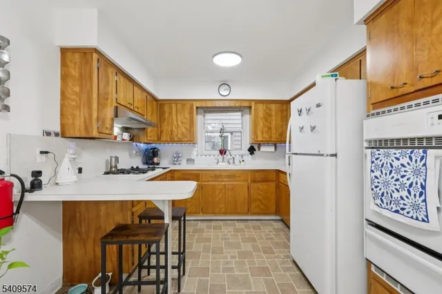 a kitchen with stainless steel appliances granite countertop a refrigerator sink and cabinets