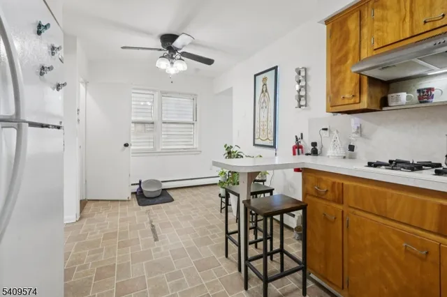 a living room with furniture a dining table and a fireplace