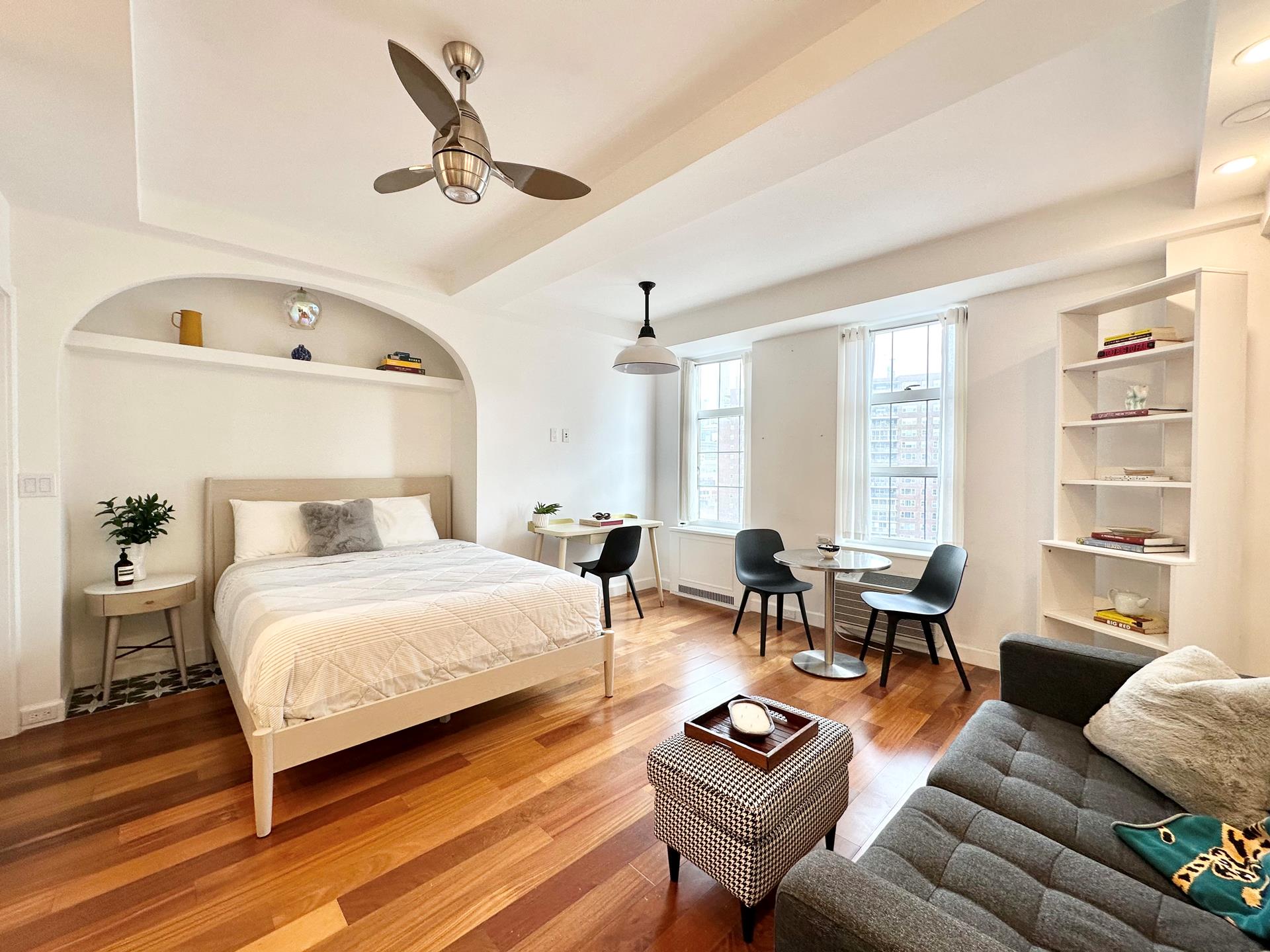 410 West 24th Street, Unit 15D Manhattan, NY 10011 - Photo 2 of 35 a bedroom with a bed a couch and a window