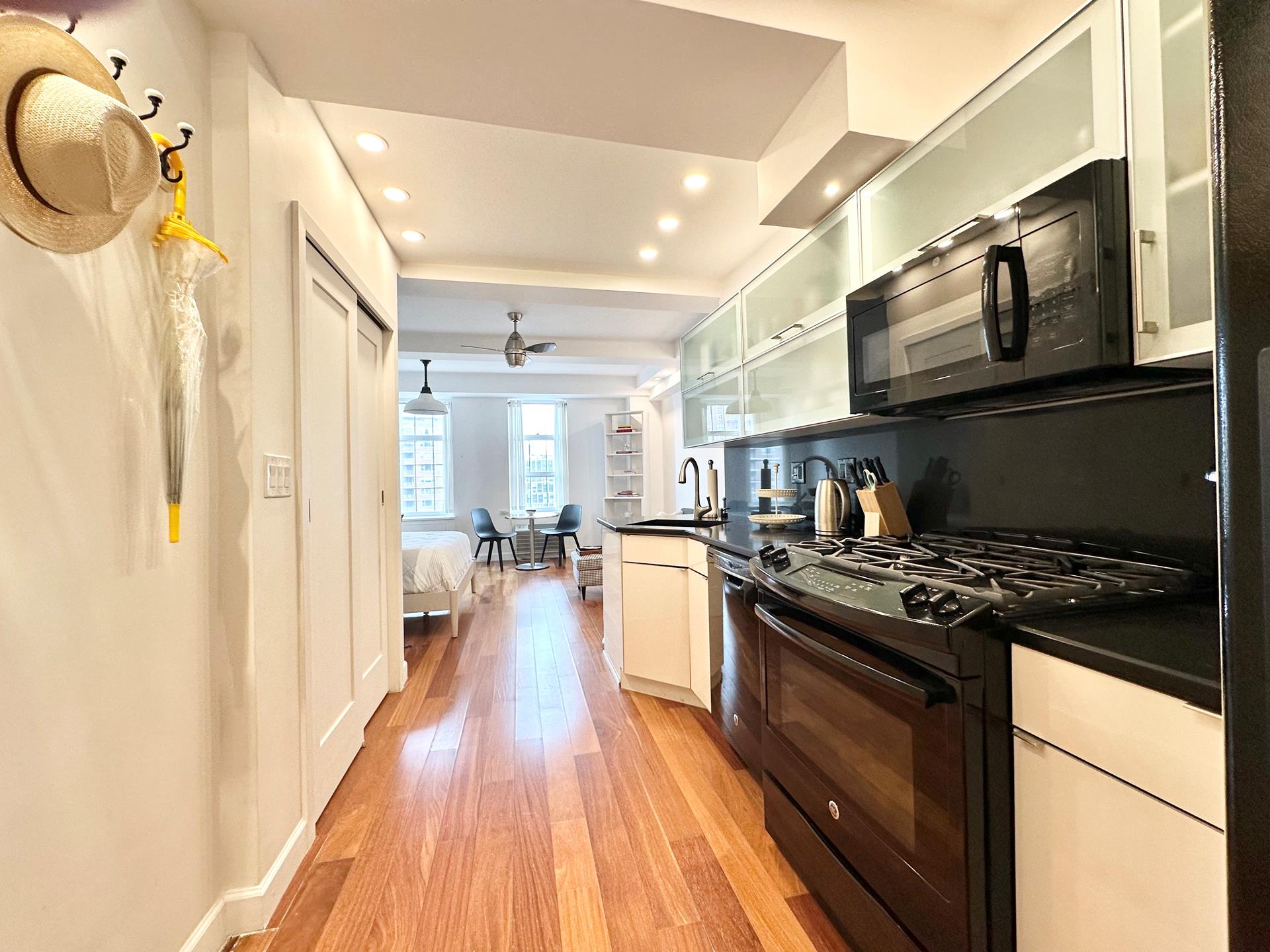 410 West 24th Street, Unit 15D Manhattan, NY 10011 - Photo 3 of 35 a kitchen with stainless steel appliances granite countertop a stove and a wooden floors