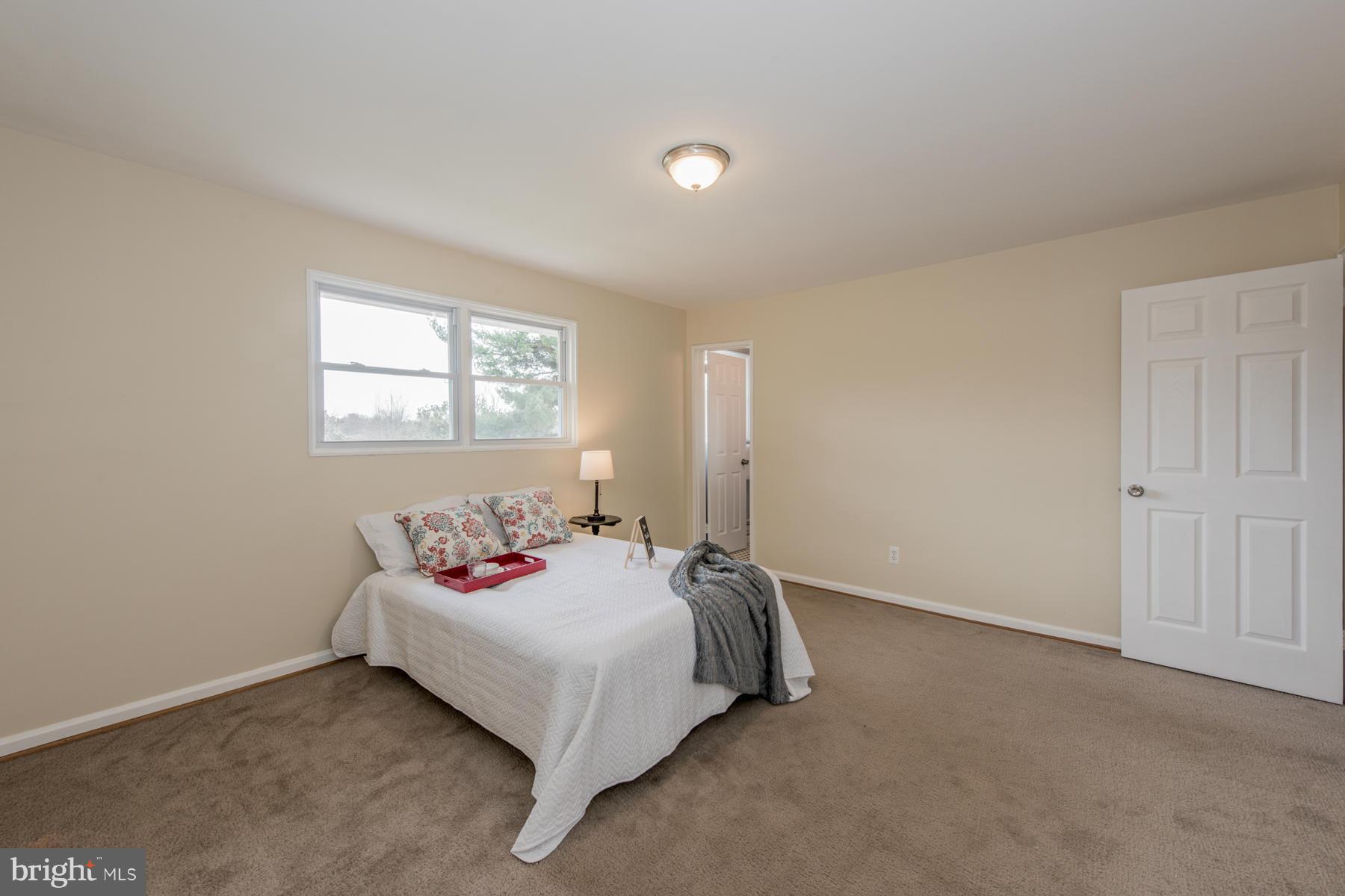11019 Oakwood Street Silver Spring, MD 20901 - Photo 15 of 30 a bedroom with a bed and a window