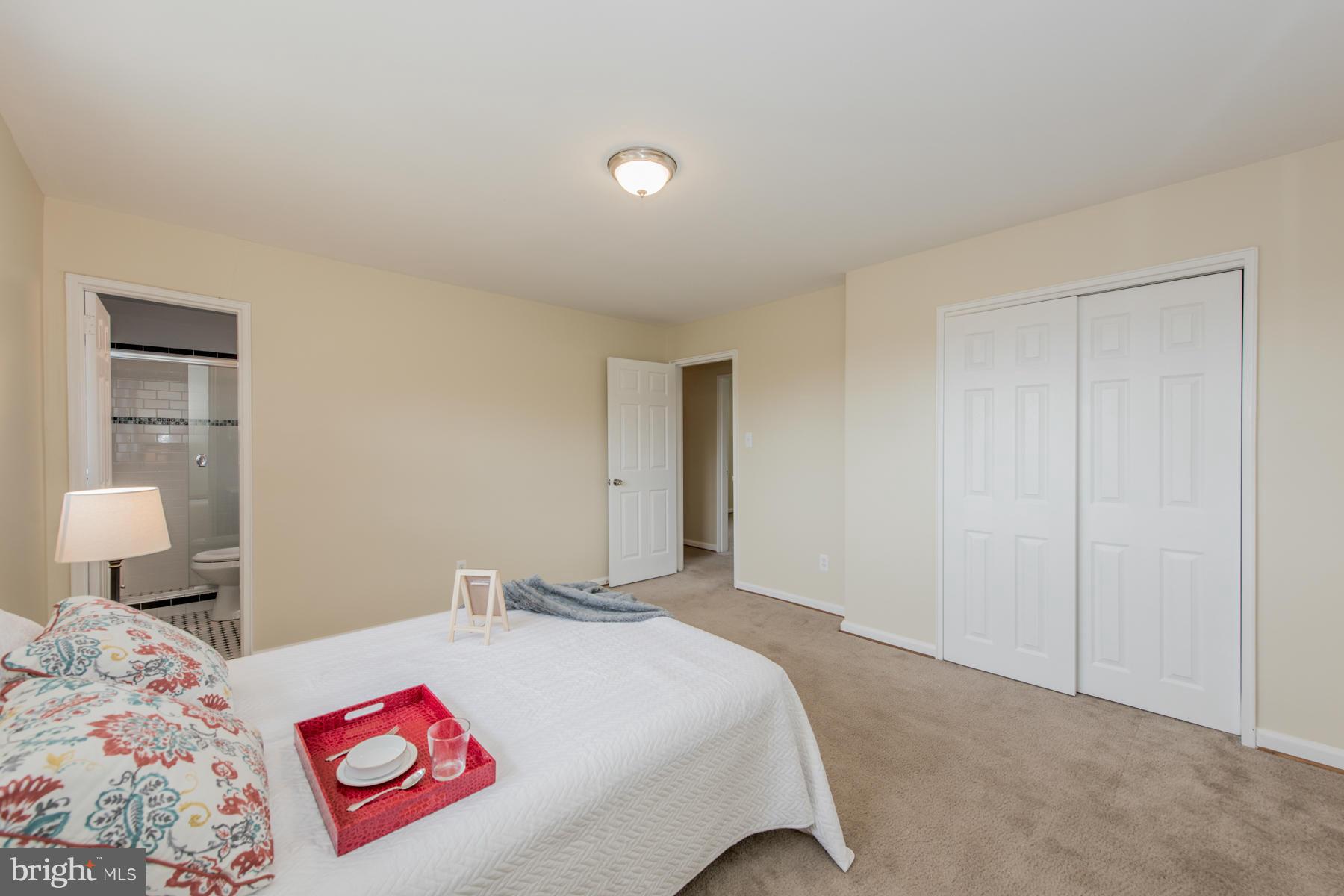 11019 Oakwood Street Silver Spring, MD 20901 - Photo 16 of 30 a bed room with a bed and a lamp