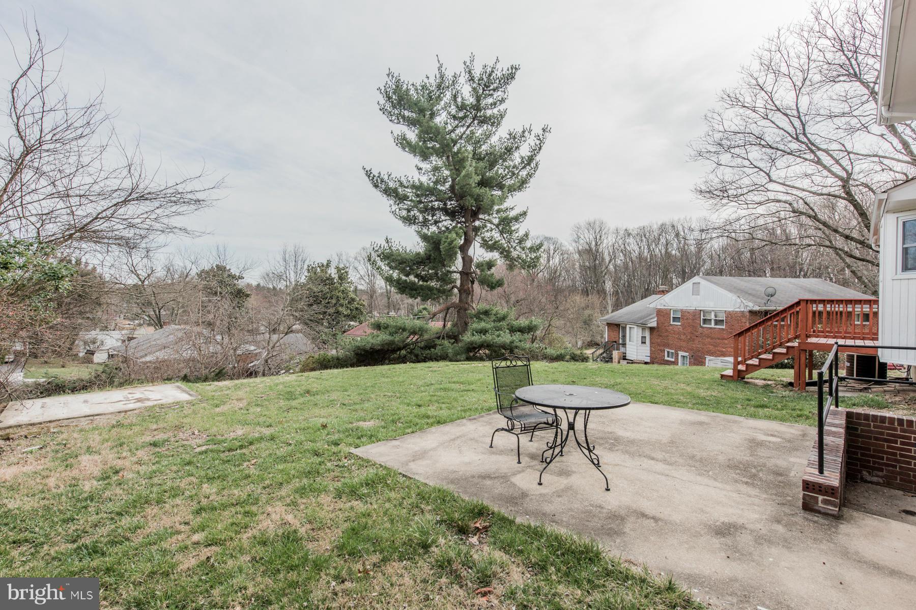 11019 Oakwood Street Silver Spring, MD 20901 - Photo 28 of 30 a view of a backyard with table and chairs under a large tree