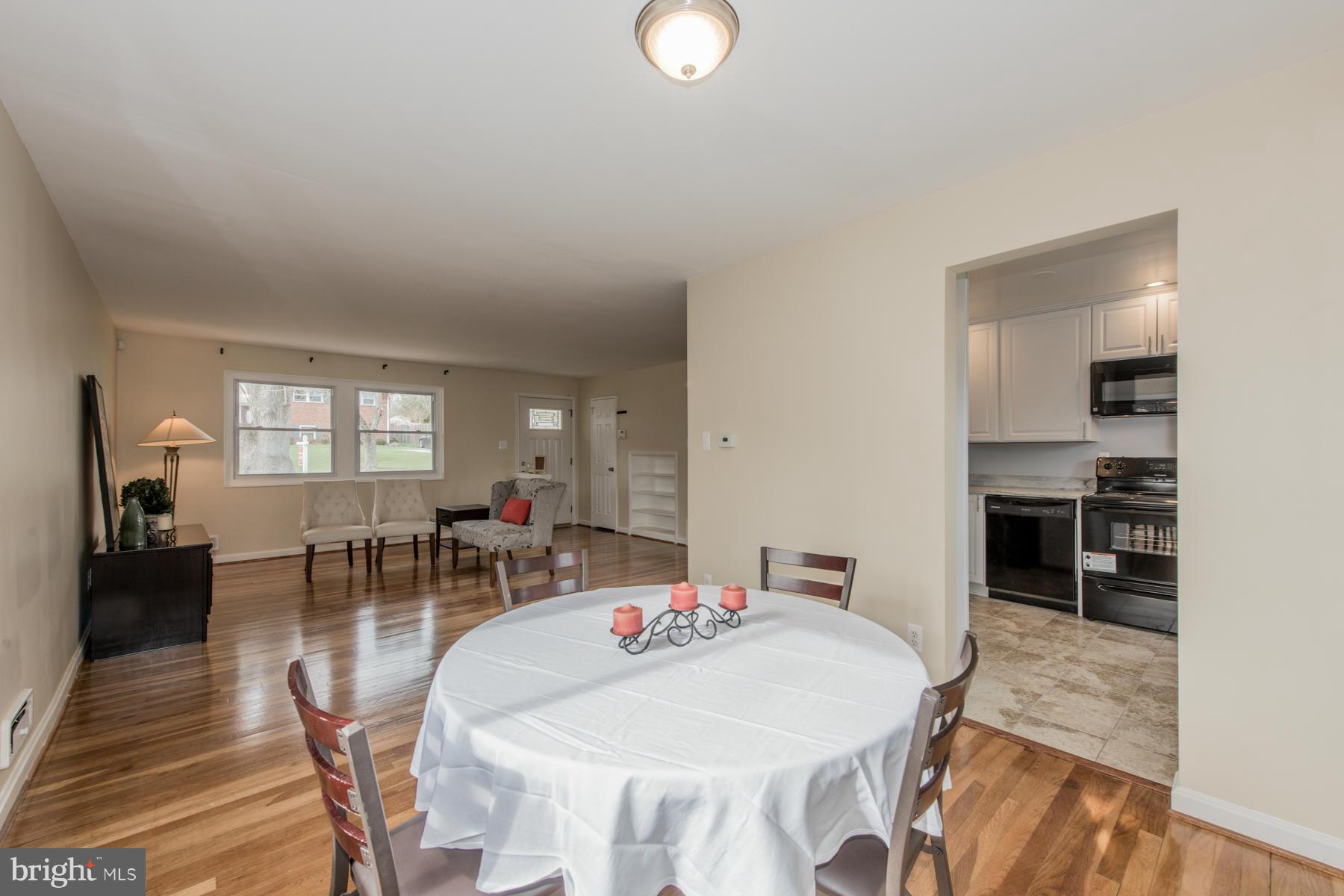 11019 Oakwood Street Silver Spring, MD 20901 - Photo 7 of 30 a view of a dining room with furniture and wooden floor