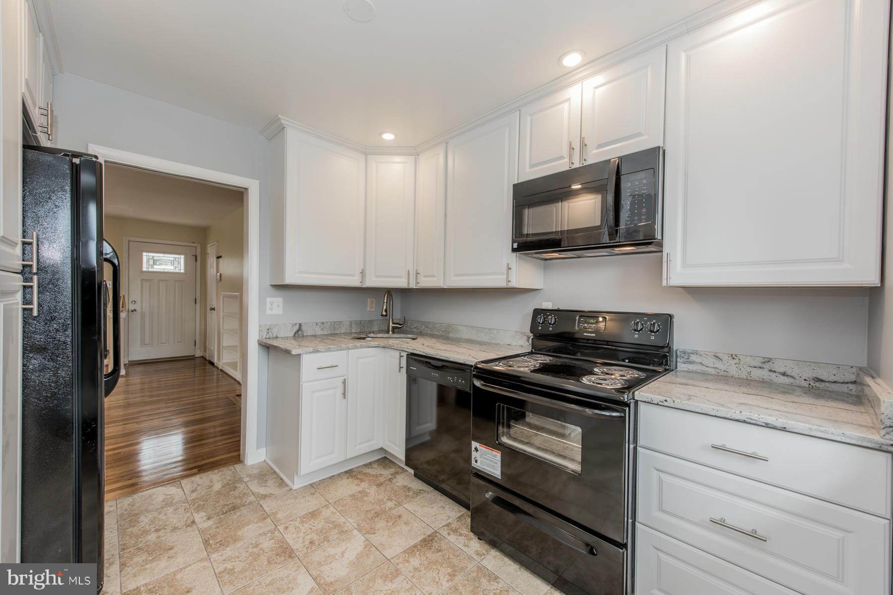 11019 Oakwood Street Silver Spring, MD 20901 - Photo 10 of 30 a kitchen with stainless steel appliances granite countertop a stove and a sink