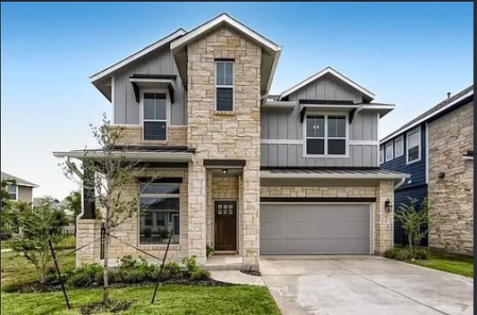 A striking modern facade blends native stone with vertical siding and clean architectural lines.