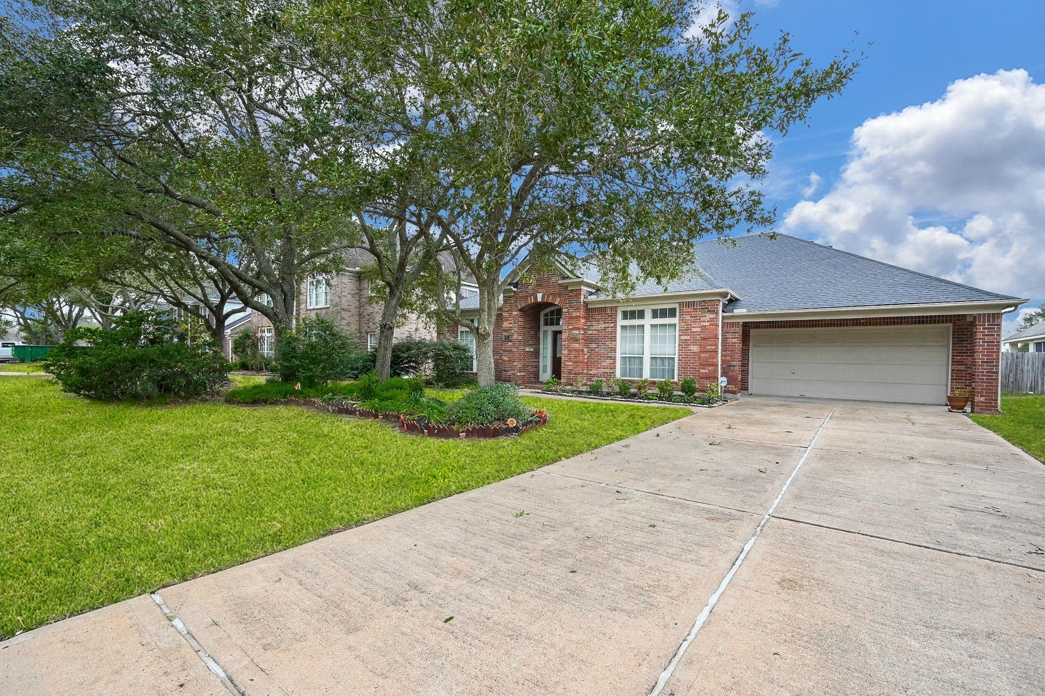 18 Crest Gate Houston, TX 77082 - Photo 17 of 46 a front view of a house with a yard and garage