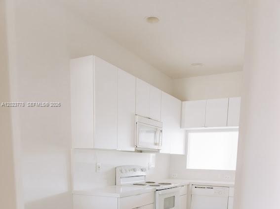 10245 Vía Hibiscus, Unit 10245 Boca Raton, FL 33428 - Photo 6 of 28 a view of white cabinets and sink