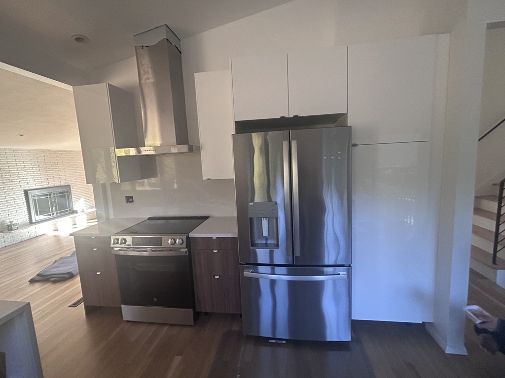 44 Marla Circle Newton, MA 02459 - Photo 5 of 23 a kitchen with stainless steel appliances a refrigerator and a stove