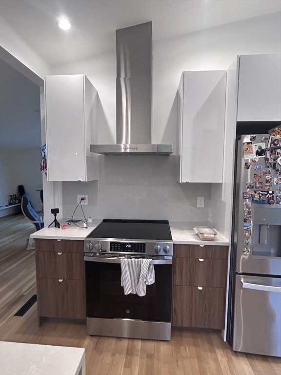 44 Marla Circle Newton, MA 02459 - Photo 6 of 23 a kitchen with stainless steel appliances granite countertop a stove a sink and a refrigerator