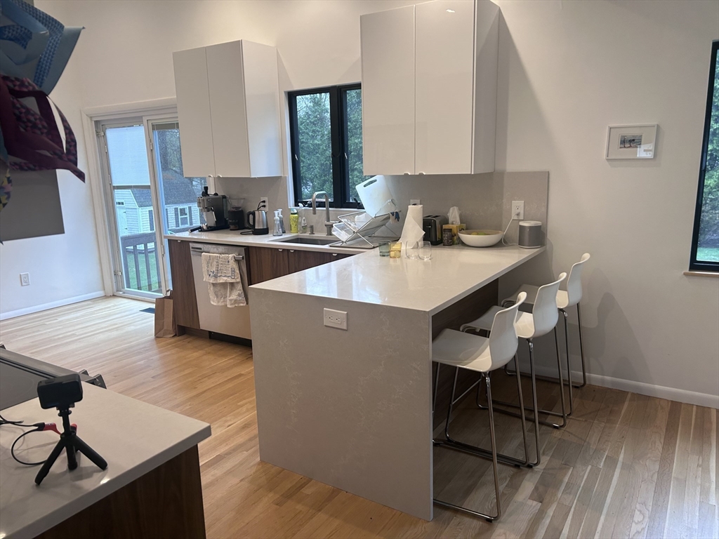 44 Marla Circle Newton, MA 02459 - Photo 8 of 23 a kitchen with a sink cabinets and wooden floor