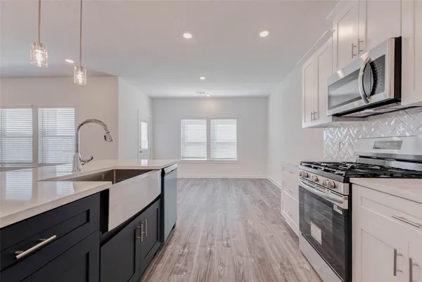 a kitchen with kitchen island cabinets and wooden floor