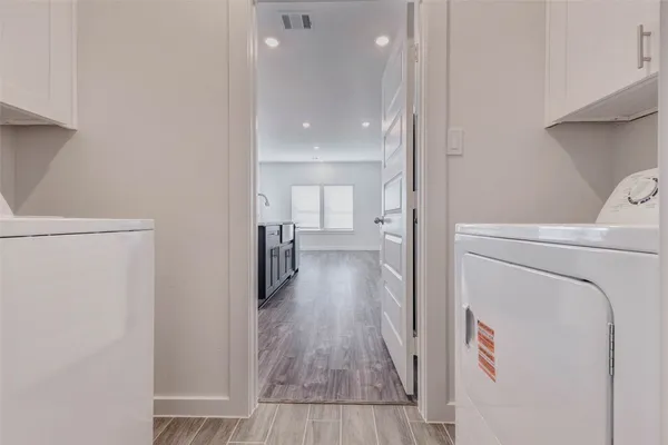 a kitchen with stainless steel appliances granite countertop wooden floors and wide window