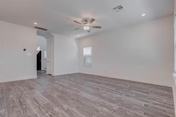 a kitchen with stainless steel appliances a sink cabinets and wooden floor
