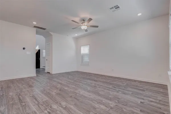 a kitchen with stainless steel appliances a sink cabinets and wooden floor
